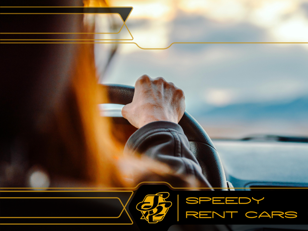 Kobieta kieruje samochodem, widać tylko jej rękę na kierownicy